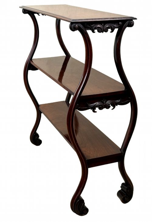 fig 4. A mid-19th century three-tier rosewood standing buffet unit featuring curved leg supports and carved scroll details.