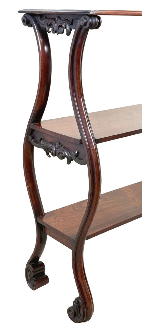 A mid-19th century three-tier rosewood standing buffet unit featuring curved leg supports and carved scroll details. View X