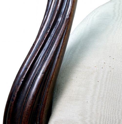fig 2. An 18th-century Georgian mahogany salon chair featuring an oval back rest, carved wooden frame, and cream silk upholstery.