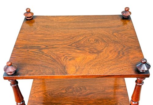 fig 2. A mid-19th-century rosewood three-tier whatnot with turned spindles, finials, and brass castors.