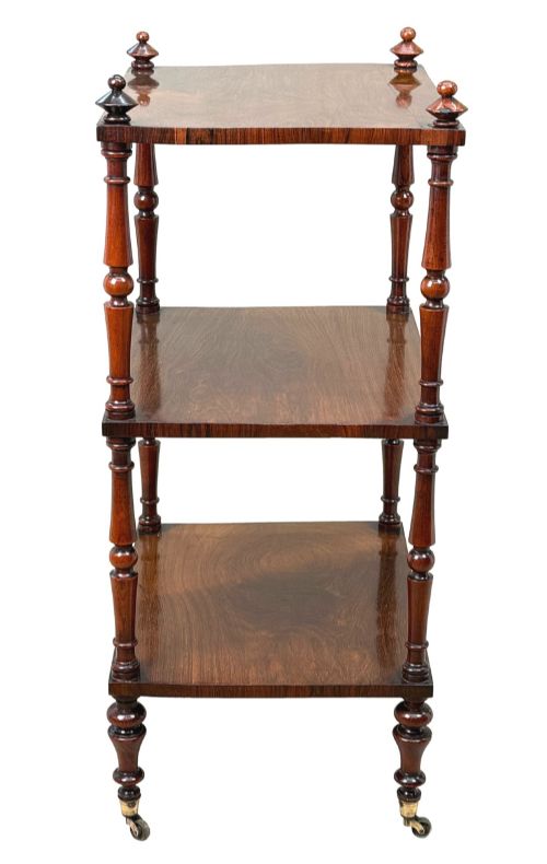 fig 3. A mid-19th-century rosewood three-tier whatnot with turned spindles, finials, and brass castors.