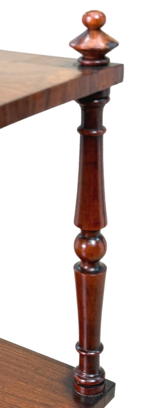 fig 4. A mid-19th-century rosewood three-tier whatnot with turned spindles, finials, and brass castors.