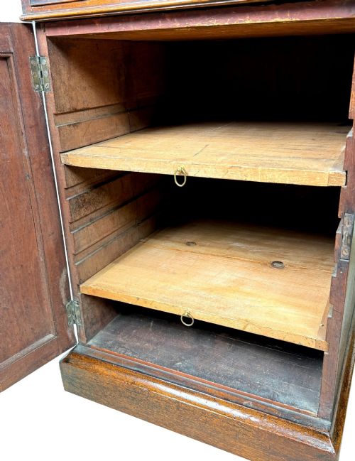 fig 3. An 18th-century Georgian mahogany partners desk featuring three top frieze drawers and twin pedestal cupboards set on a plinth base.