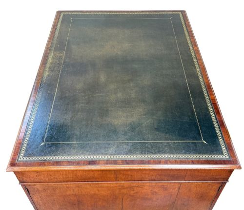fig 4. An 18th-century Georgian mahogany partners desk featuring three top frieze drawers and twin pedestal cupboards set on a plinth base.
