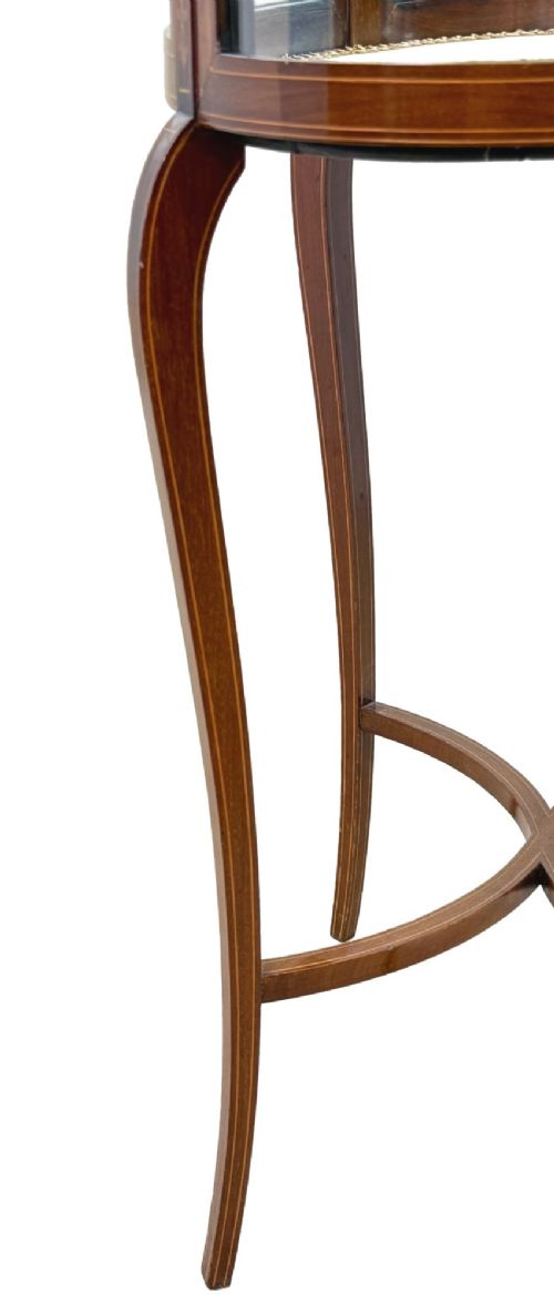 An oval late 19th-century mahogany bijouterie display table featuring glass side panels, inlaid floral marquetry, slender cabriole legs, and a cross stretcher. View VII