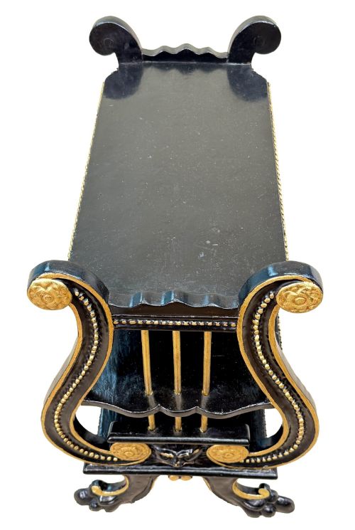 fig 2. A late nineteenth-century ebonised three-tiered etagere featuring lyre-shaped side supports, gilt bead trim along the shelf edges, and carved scroll feet.