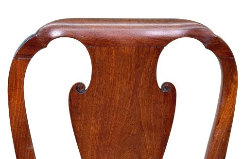 fig 2. A pair of early 18th-century Queen Anne walnut side chairs featuring vase-shaped back splats, curved cabriole front legs, and cream upholstered drop-in seats.