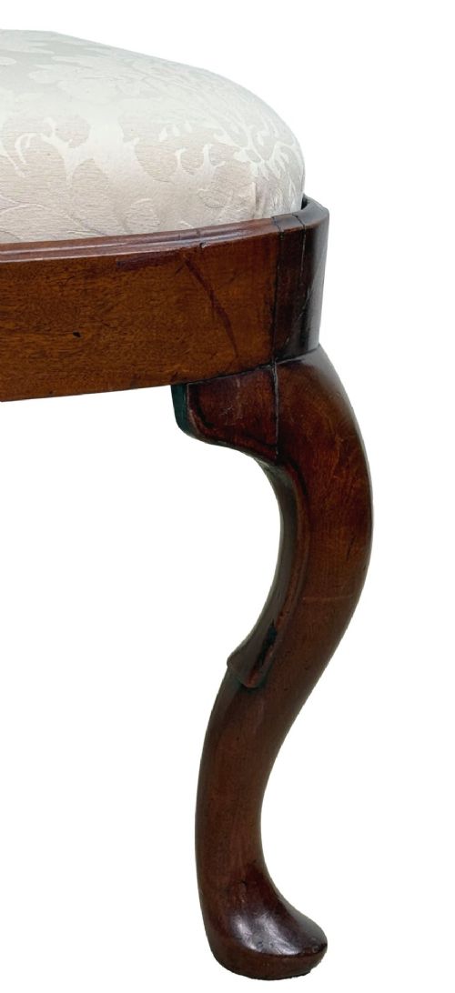 A pair of early 18th-century Queen Anne walnut side chairs featuring vase-shaped back splats, curved cabriole front legs, and cream upholstered drop-in seats. View IX