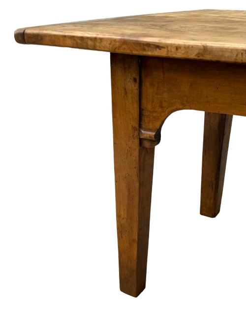fig 1. An early 19th-century French Provincial sycamore farmhouse dining table featuring a light wood plank top and tapered square legs.