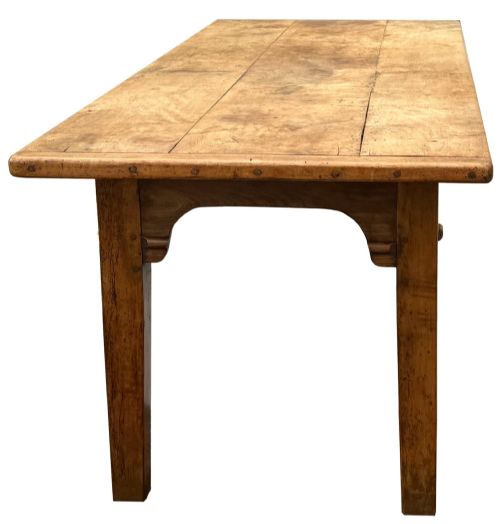 fig 2. An early 19th-century French Provincial sycamore farmhouse dining table featuring a light wood plank top and tapered square legs.
