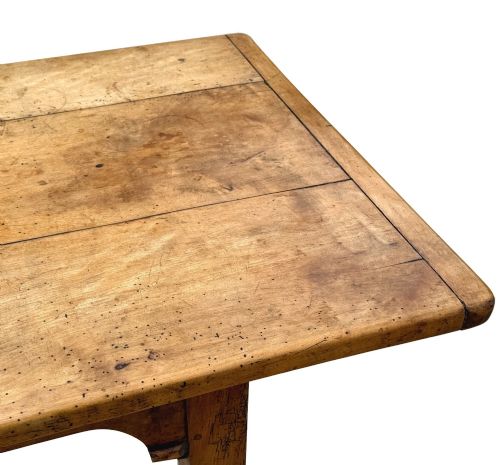 fig 3. An early 19th-century French Provincial sycamore farmhouse dining table featuring a light wood plank top and tapered square legs.