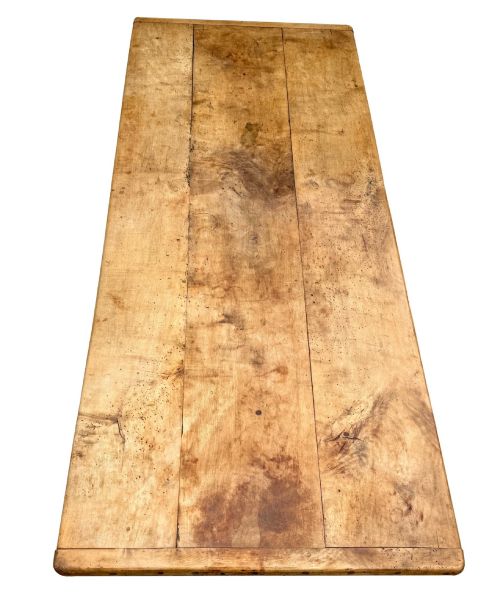 fig 5. An early 19th-century French Provincial sycamore farmhouse dining table featuring a light wood plank top and tapered square legs.