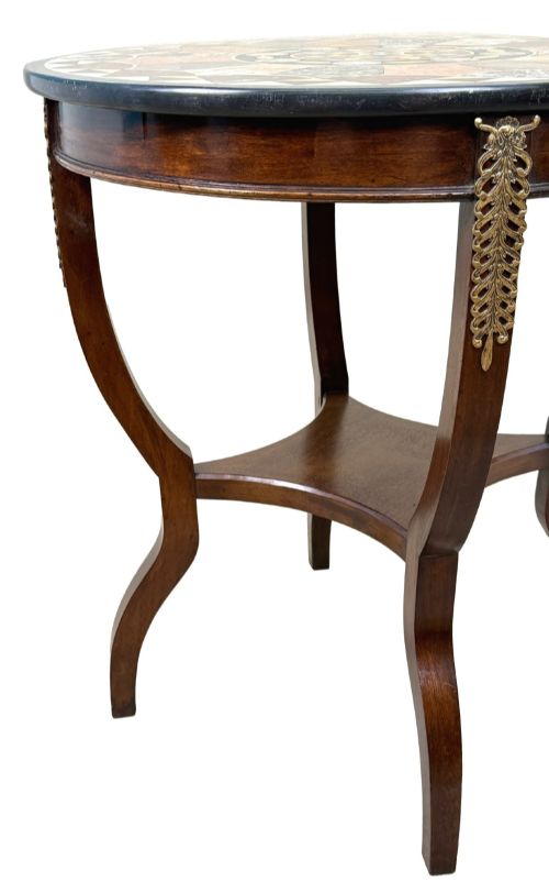 fig 3. A late nineteenth-century circular mahogany occasional table featuring a specimen marble top, outcurving legs with gilt mounts, and a lower undertier.