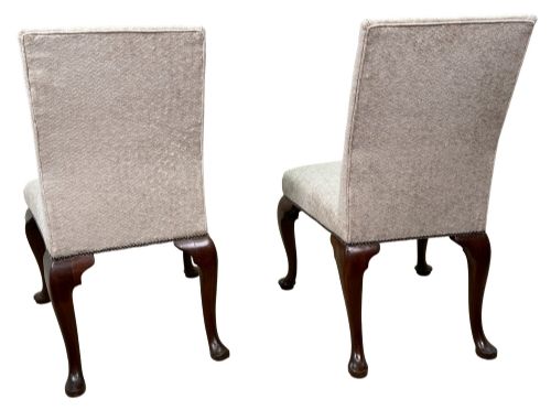 fig 3. A pair of Georgian walnut side chairs featuring cream textured upholstery and carved cabriole legs ending in pad feet.