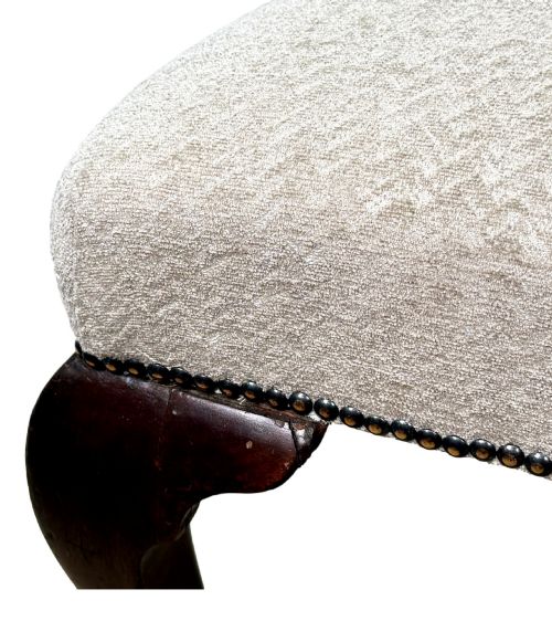 fig 5. A pair of Georgian walnut side chairs featuring cream textured upholstery and carved cabriole legs ending in pad feet.