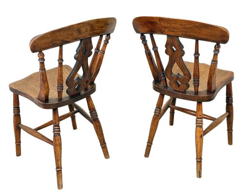 fig 2. A set of six Victorian wooden Windsor dining chairs featuring shaped crest rails, pierced back splats, contoured saddle seats, and turned legs.