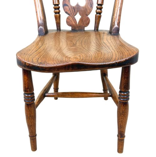 fig 3. A set of six Victorian wooden Windsor dining chairs featuring shaped crest rails, pierced back splats, contoured saddle seats, and turned legs.