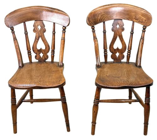 fig 5. A set of six Victorian wooden Windsor dining chairs featuring shaped crest rails, pierced back splats, contoured saddle seats, and turned legs.
