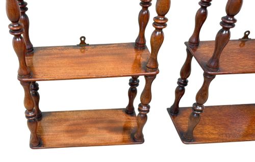 fig 4. A pair of tall mid-19th-century mahogany wall-hanging shelves featuring five open tiers supported by turned spindles.