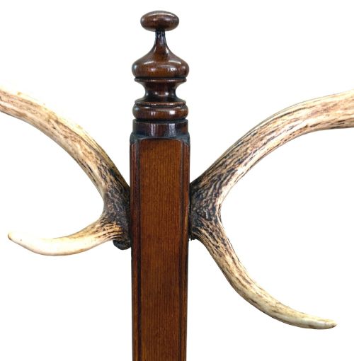 fig 2. A 19th-century dark walnut hall stand featuring a central turned column mounted with stag antler hooks and a circular dish base.