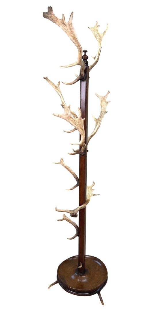 fig 3. A 19th-century dark walnut hall stand featuring a central turned column mounted with stag antler hooks and a circular dish base.