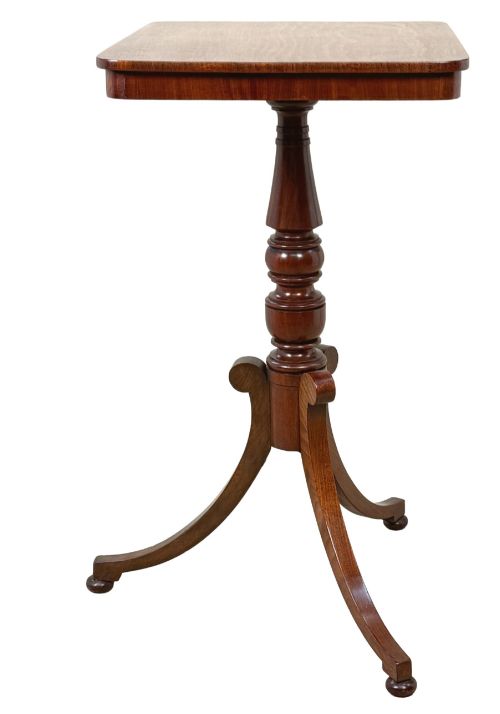 fig 1. A Regency period mahogany wine table with a rectangular top, a turned central pedestal column, and three splayed legs ending in ball feet.