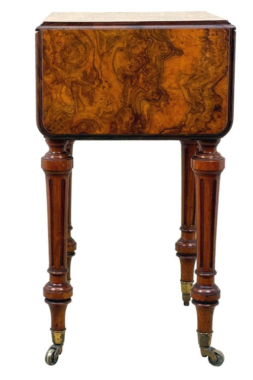 fig 1. A 19th-century burr walnut Pembroke side table with a single drawer, two drop-down side leaves, turned fluted legs, and brass castors.