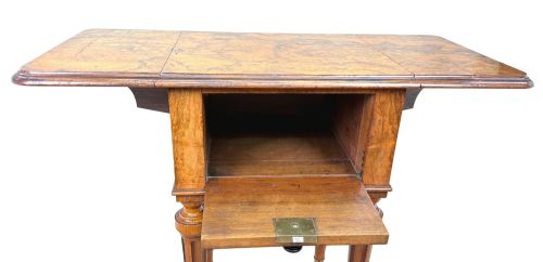 fig 3. A 19th-century burr walnut Pembroke side table with a single drawer, two drop-down side leaves, turned fluted legs, and brass castors.