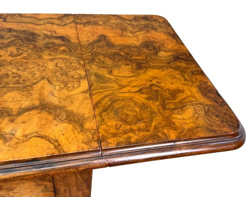 fig 4. A 19th-century burr walnut Pembroke side table with a single drawer, two drop-down side leaves, turned fluted legs, and brass castors.