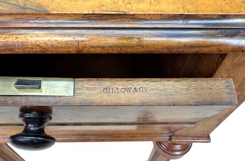 fig 5. A 19th-century burr walnut Pembroke side table with a single drawer, two drop-down side leaves, turned fluted legs, and brass castors.