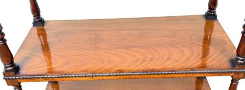 fig 4. An early nineteenth-century Regency mahogany three-tiered etagere whatnot with turned supports, finials, a lower drawer, and brass castors.