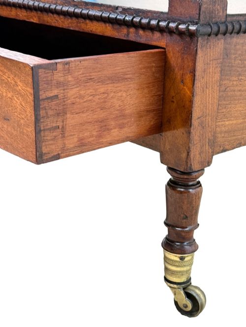 fig 5. An early nineteenth-century Regency mahogany three-tiered etagere whatnot with turned supports, finials, a lower drawer, and brass castors.