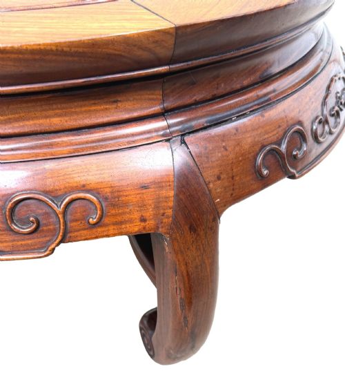 fig 2. A circular 19th-century Chinese export hardwood coffee table featuring an inset burr wood top, carved scroll aprons, and curved legs.