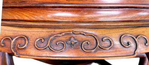 fig 4. A circular 19th-century Chinese export hardwood coffee table featuring an inset burr wood top, carved scroll aprons, and curved legs.