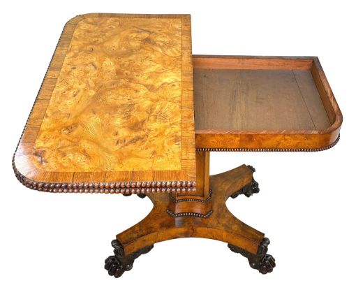 fig 4. An early 19th-century Regency period pollard oak fold-over tea table featuring a rectangular top, beaded edging, a central pedestal support, and a quadripartite base resting on carved claw feet.