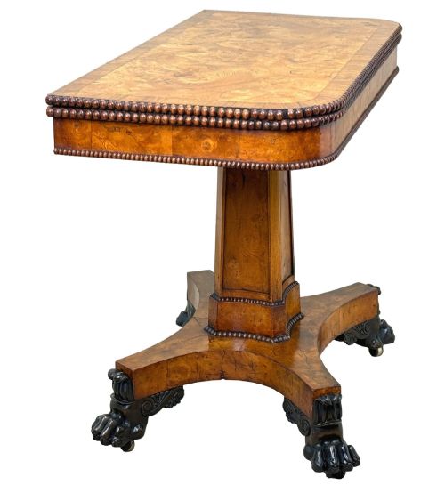 fig 5. An early 19th-century Regency period pollard oak fold-over tea table featuring a rectangular top, beaded edging, a central pedestal support, and a quadripartite base resting on carved claw feet.