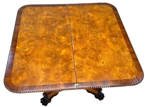 fig 6. An early 19th-century Regency period pollard oak fold-over tea table featuring a rectangular top, beaded edging, a central pedestal support, and a quadripartite base resting on carved claw feet.