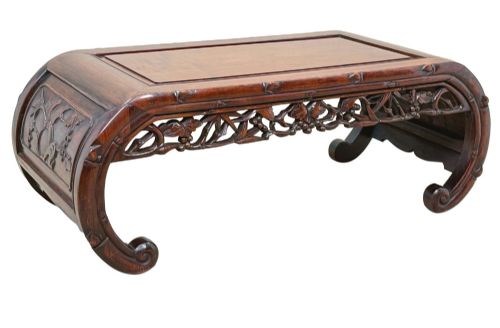 fig 5. A 19th-century dark hardwood Chinese export opium coffee table featuring scrolled legs and intricately carved pierced floral aprons.