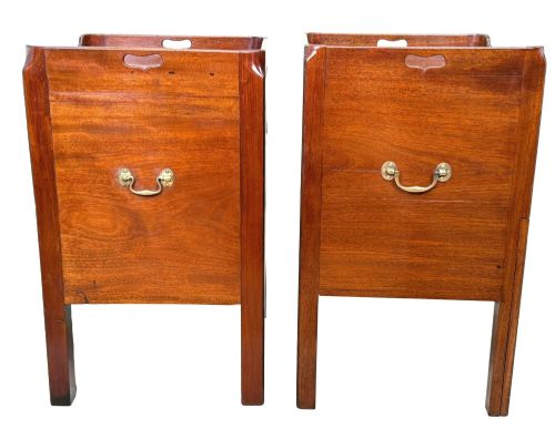 fig 1. A matched pair of Georgian mahogany bedside tables featuring top tray galleries with cutout handles, double cupboard doors, lower drawers, and brass hardware.
