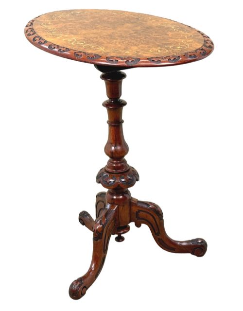 fig 1. A Victorian burr walnut oval occasional table with marquetry inlay top, a turned central pedestal, and carved tripod cabriole feet.