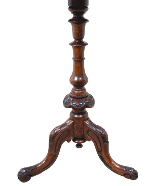 fig 2. A Victorian burr walnut oval occasional table with marquetry inlay top, a turned central pedestal, and carved tripod cabriole feet.