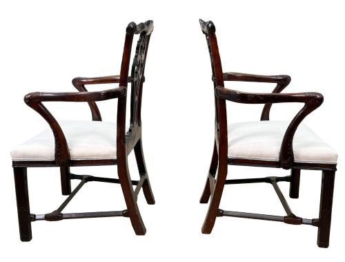 fig 3. A pair of 18th-century Chippendale mahogany carver armchairs featuring intricately carved pierced back splats, curved arms, and neutral upholstered drop-in seats.