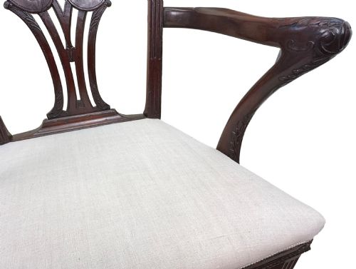 fig 4. A pair of 18th-century Chippendale mahogany carver armchairs featuring intricately carved pierced back splats, curved arms, and neutral upholstered drop-in seats.