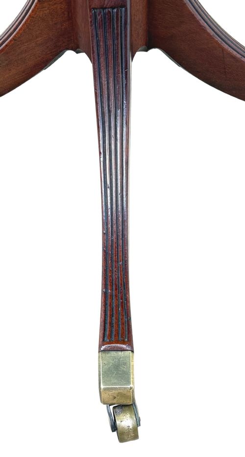fig 3. Late eighteenth-century George III mahogany circular lamp table featuring a fluted stem and four reeded legs with brass castors.