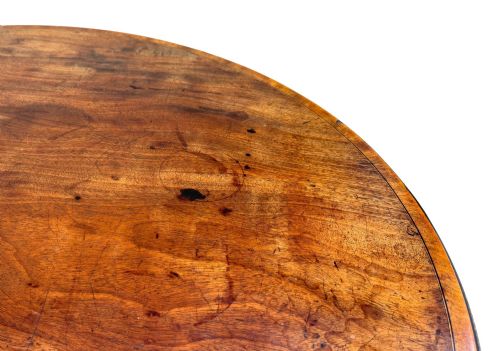 fig 4. Late eighteenth-century George III mahogany circular lamp table featuring a fluted stem and four reeded legs with brass castors.