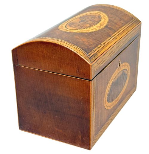 fig 1. A late 18th-century George III wooden tea caddy featuring a domed lid, intricate marquetry inlay with central oval medallions, and geometric border stringing.