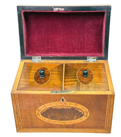 fig 2. A late 18th-century George III wooden tea caddy featuring a domed lid, intricate marquetry inlay with central oval medallions, and geometric border stringing.