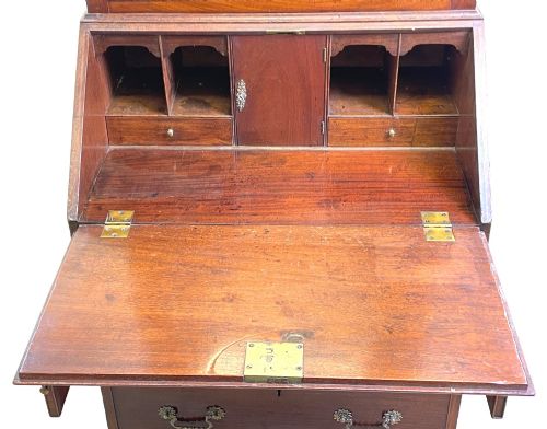 fig 1. A Georgian mahogany bureau bookcase featuring an upper mirrored cabinet door above a slant-front desk and three lower drawers.
