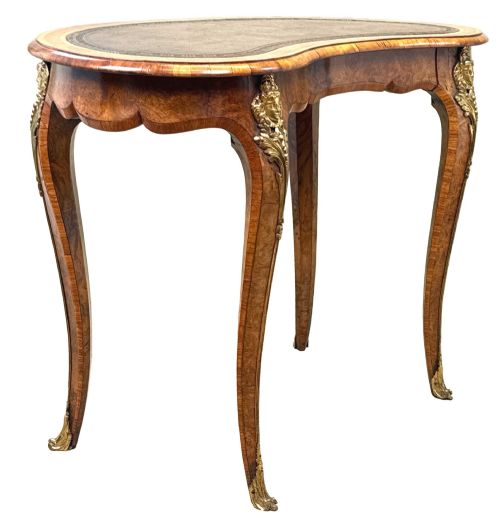fig 1. A 19th-century burr walnut kidney-shaped writing table featuring an inset leather top, gilt bronze espagnolette mounts, and cabriole legs.