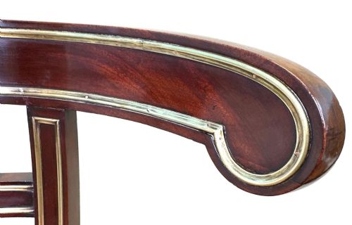fig 4. A pair of 19th-century French mahogany curved-back salon chairs with brass mounts, spindle details, woven cane seats, and turned front legs.
